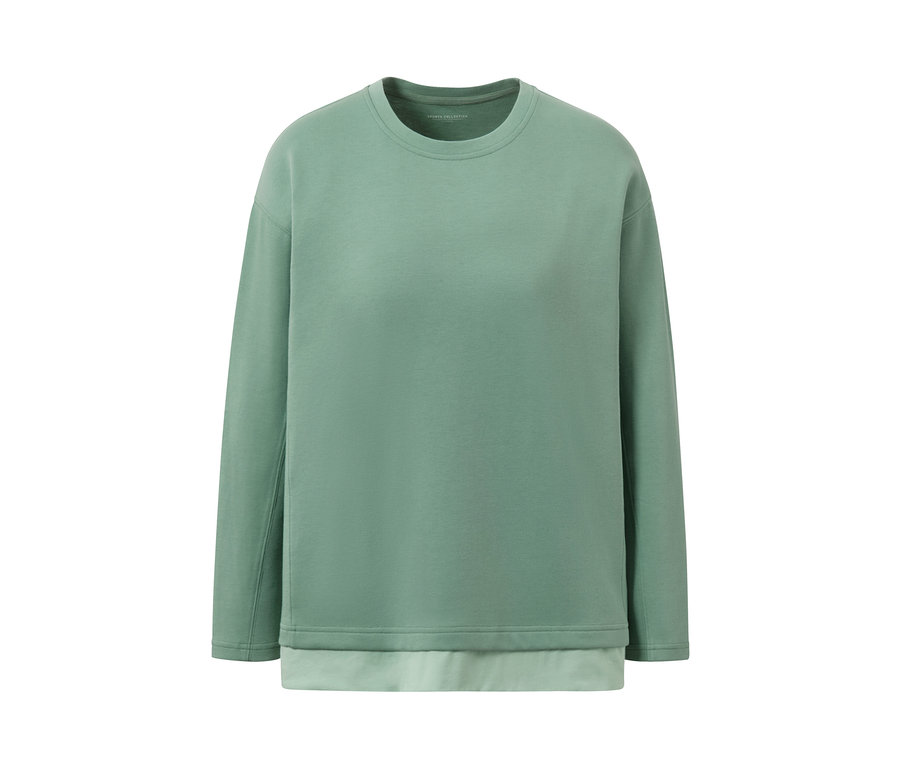 Egy zöld, oversized fitnesz hosszú ujjú felső fehér háttérrel.