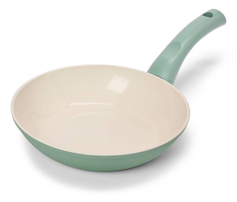 Egy világoszöld serpenyő krémszínű belsővel fekszik egy fehér háttéren.
