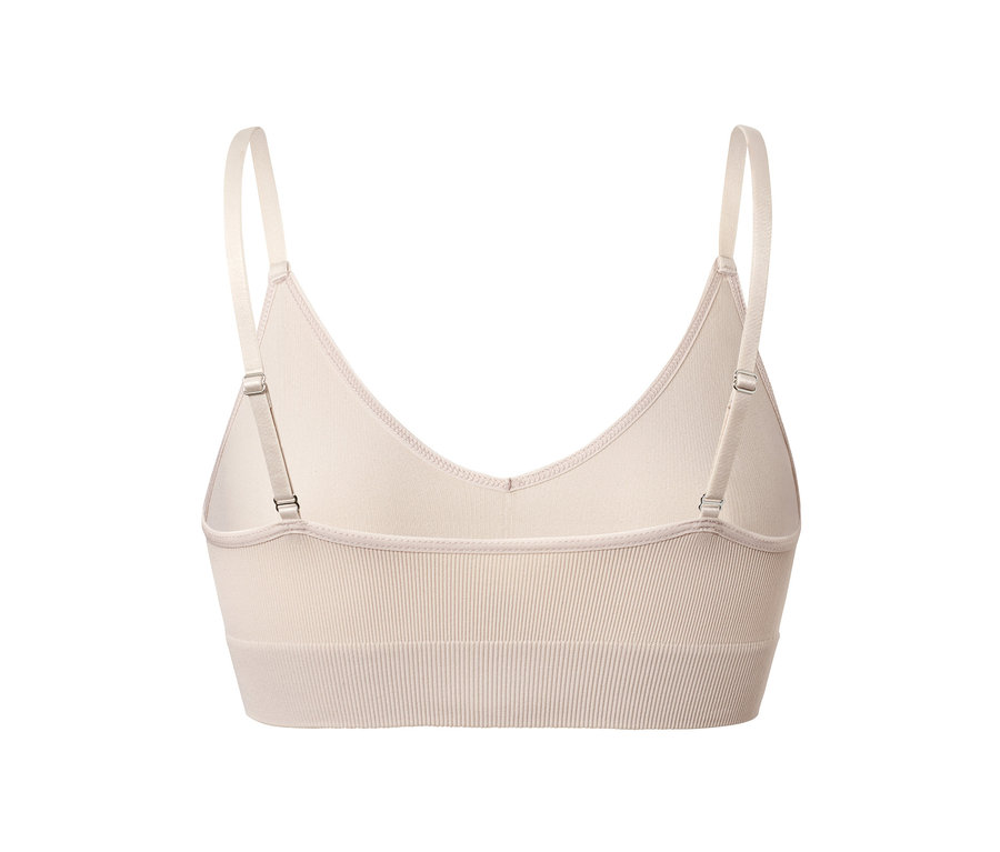 Hátulnézet egy bézs színű, varrás nélküli, állítható pántokkal ellátott bustier-ről.