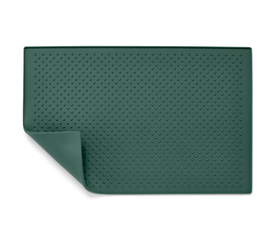 Egy zöld, texturált alátét etetőtálhoz.