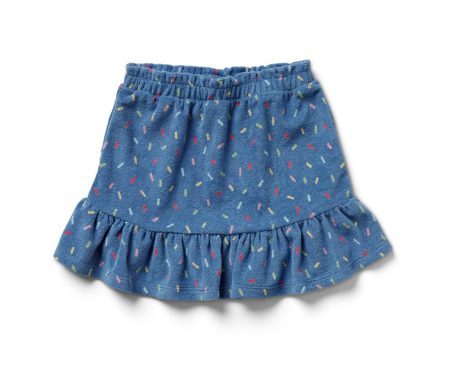 Egy kék frottír szoknya színes cukorkaszórással.