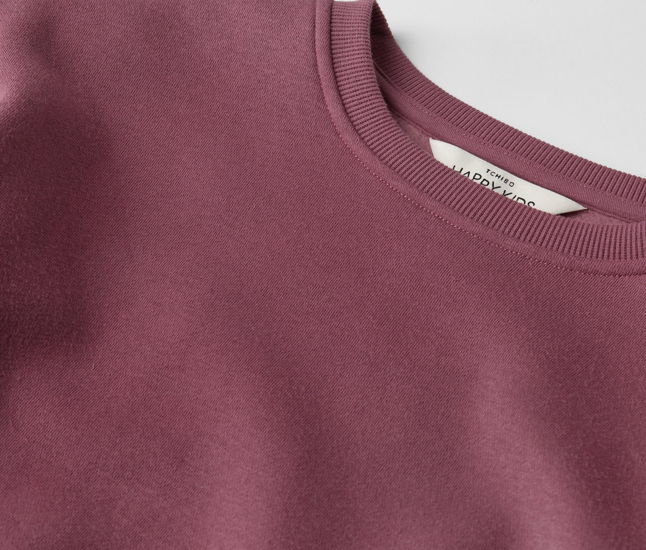 Egy Kinder-Sweatkleid részlete.