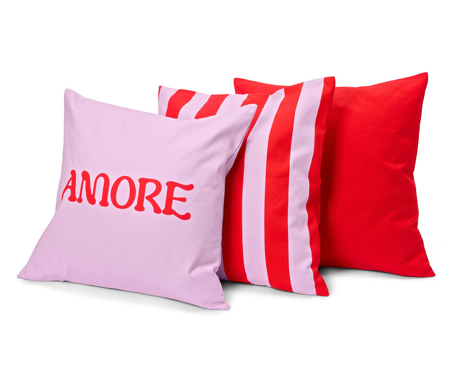 Három párna: egy lila, piros „AMORE” felirattal, egy csíkos, piros-lila és egy egyszínű piros.