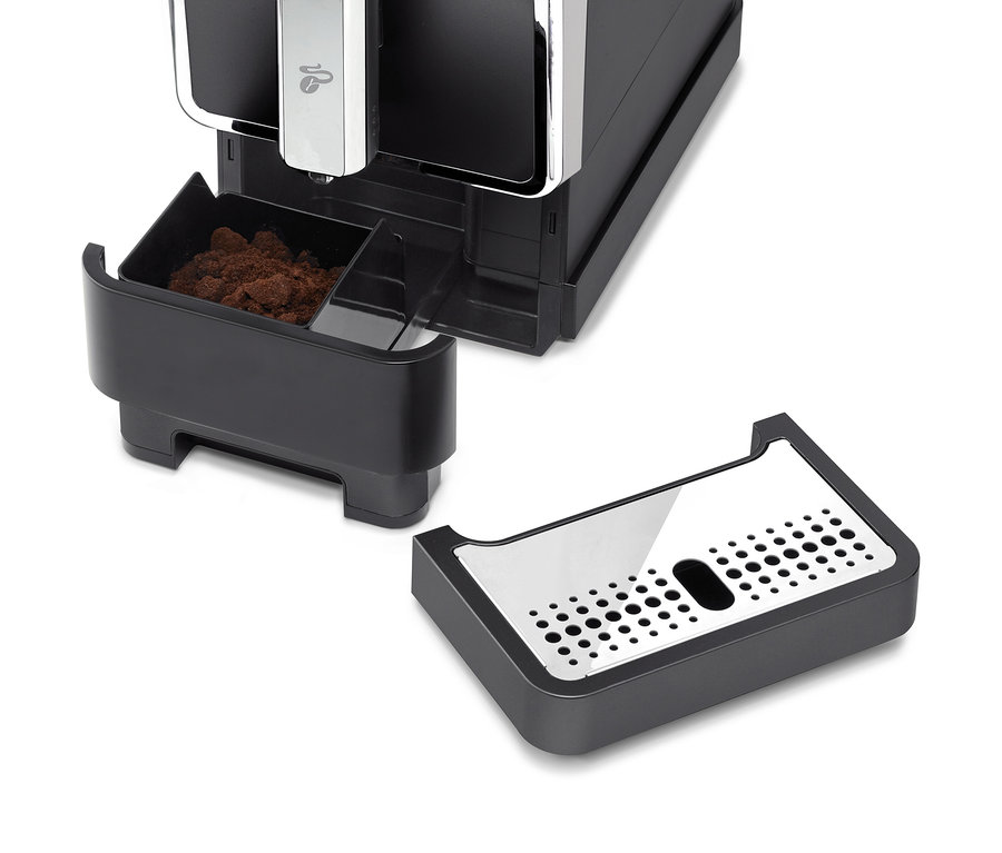 Közelkép egy antracit színű »Esperto Caffè« Tchibo automata kávéfőzőről csepegtetőtálcával.