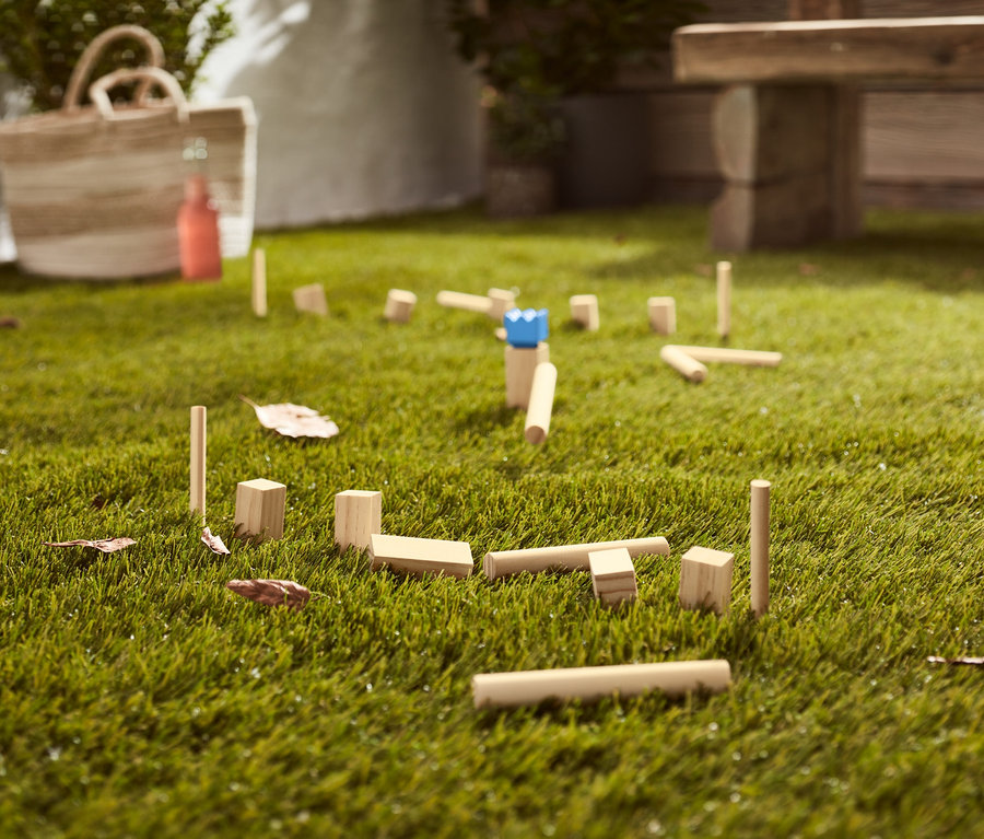 A füvön mini kubb játék van elterítve.