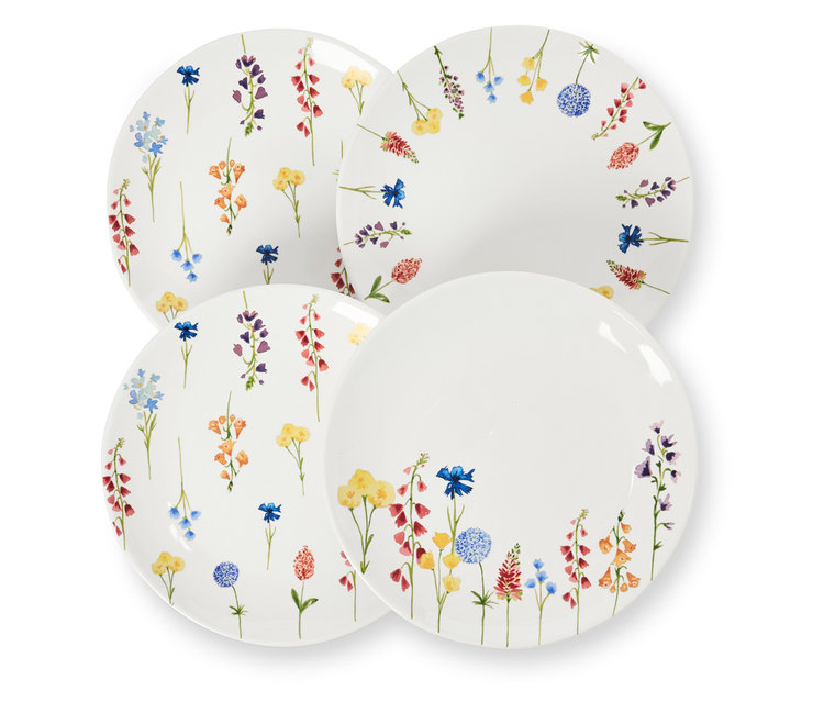 Négy virágmintás desszertes tányér egymáson.