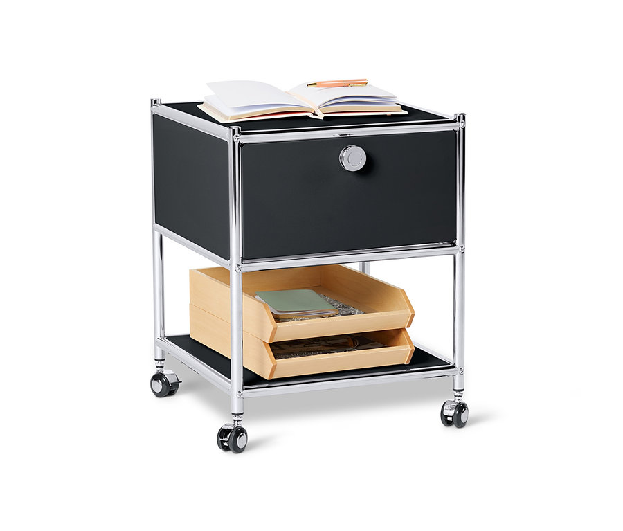 Fekete, fiókos fém kisasztal »CN3«, a tetején nyitott könyvvel.