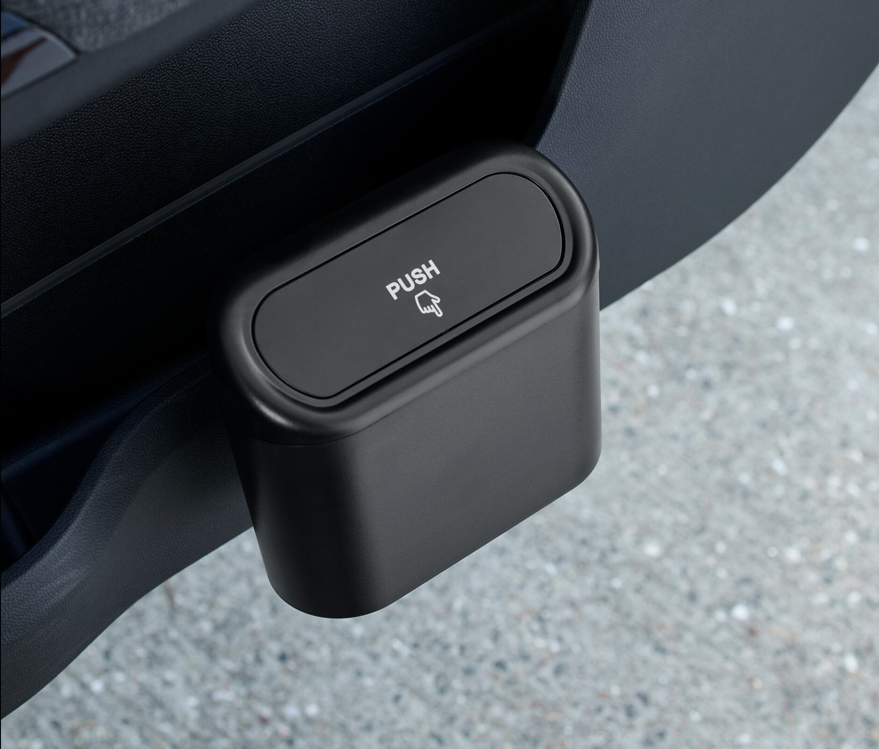 Egy fekete autós szemetes az autó ajtajában.