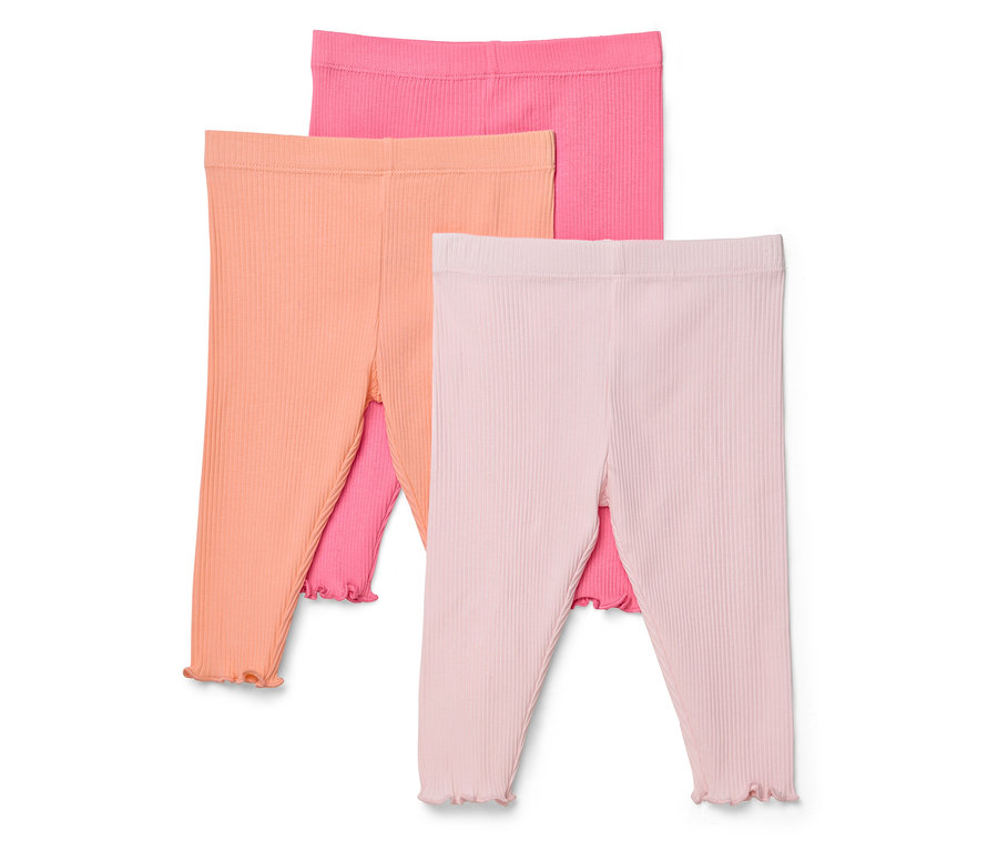 Három rózsaszín, narancssárga és rózsaszín bordázott leggings egymáson fekszik.