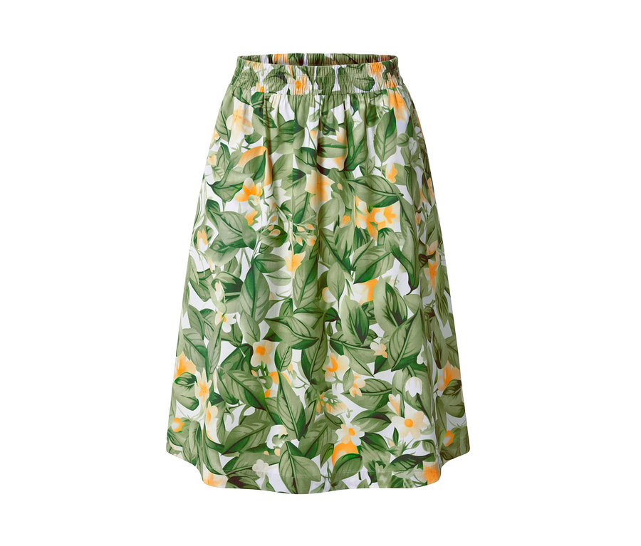 Nyomott mintás poplin szoknya zöld levelekkel és sárga virágokkal fehér háttéren.