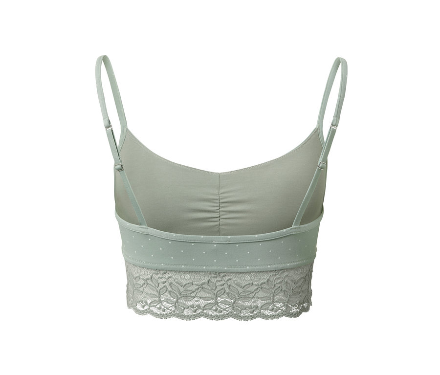 Hátulnézet egy világoszöld, csipkés és vékony pántos női bustier melltartóról.