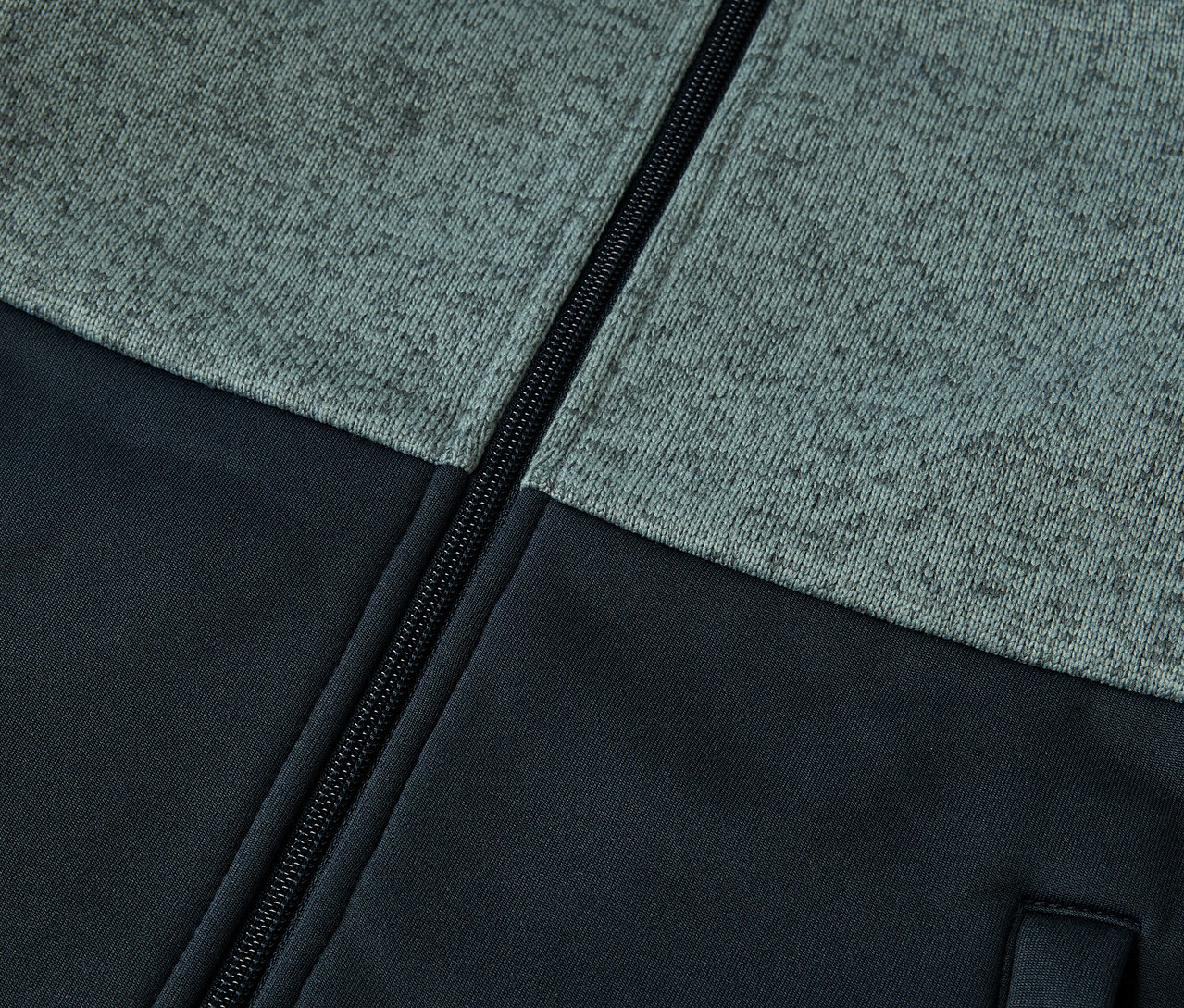 Egy cipzáras, kötött, hibrid gyermek fleece kabát részlete.