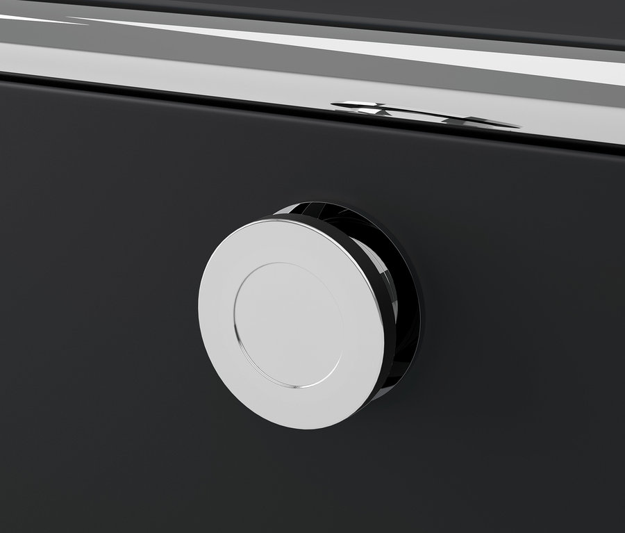 Egy fekete CN3 fém bútor részlete, kerek, ezüst fogantyúval.