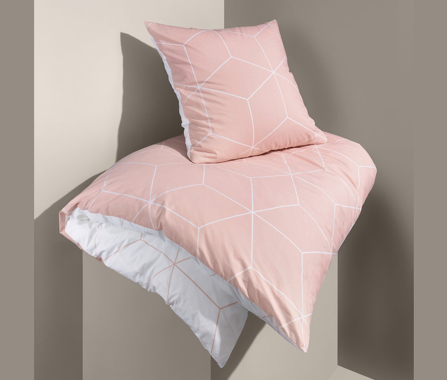 Egy geometriai mintás, normál méretű, hajtogatott kétoldalas perkál ágynemű van egymáson.