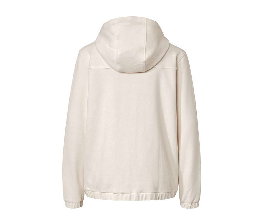 Hátulnézet egy krémfehér szabadidőfelsőről.