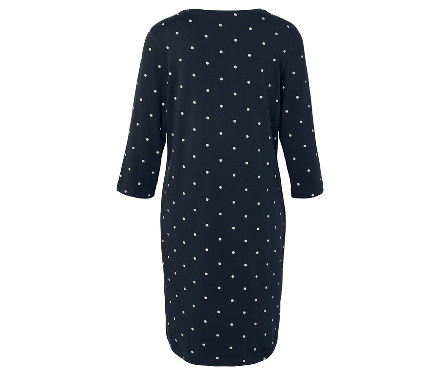 Hátulnézet egy sötétkék, fehér pöttyös, háromnegyedes ujjú ruháról.