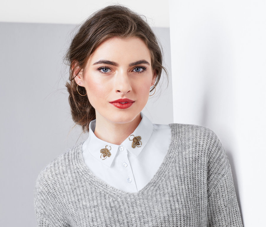 Nő visel egy hamis gallért méhecske gyöngyhímzéssel.