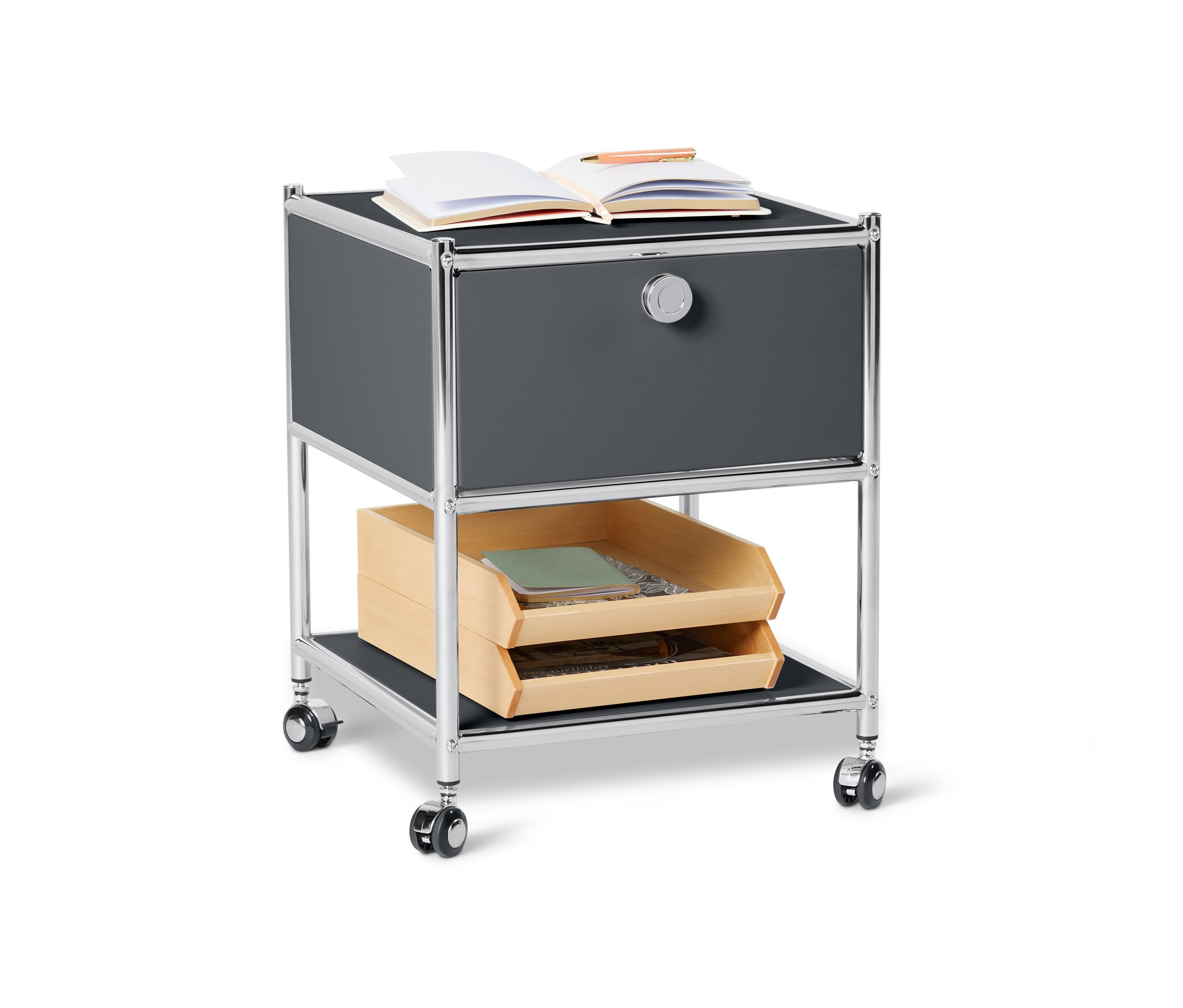 Szürke, fiókos fém kisasztal »CN3«. A tetején egy nyitott jegyzetfüzet és egy toll található.