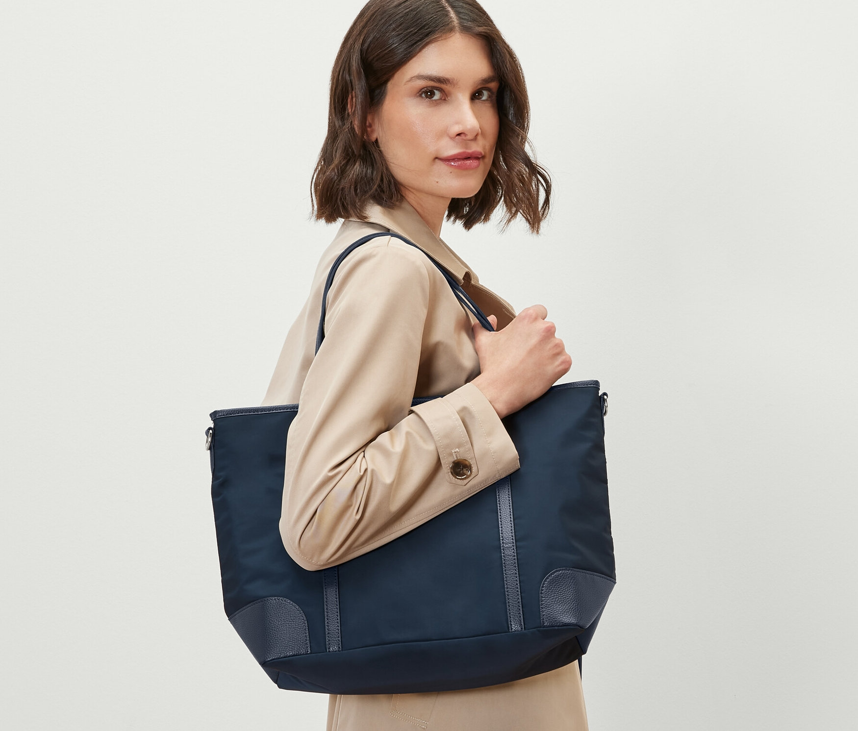 Nő tart egy sötétkék női shopper táskát.