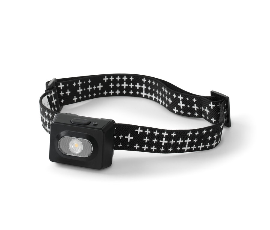 Fekete fejlámpa fehér kereszt mintával a pánton.