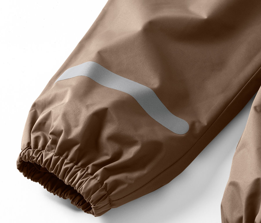 Egy gyermek esőnadrág részlete, fényvisszaverő csíkkal a száron.