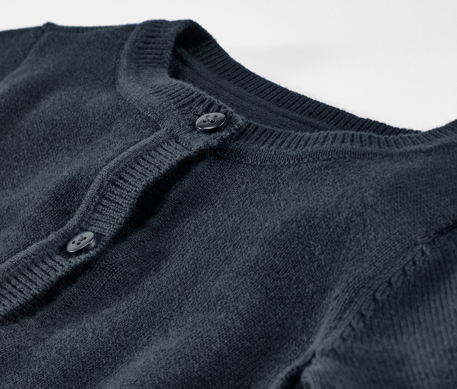 Kötött gyerekkardigán részletgazdag felvétele gombokkal.