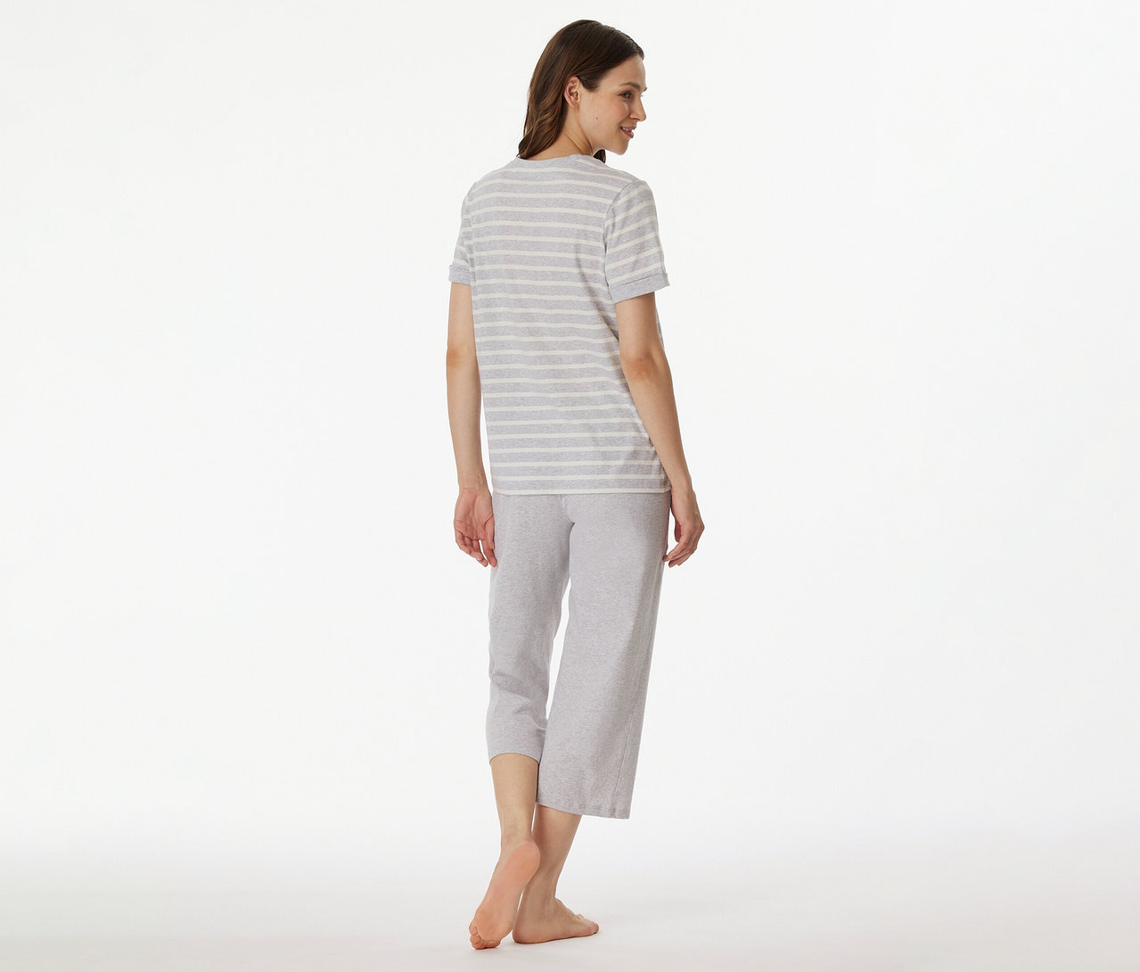 Hátulról egy szürke-fehér csíkos SCHIESSER 3/4-es pizsamában lévő nő.