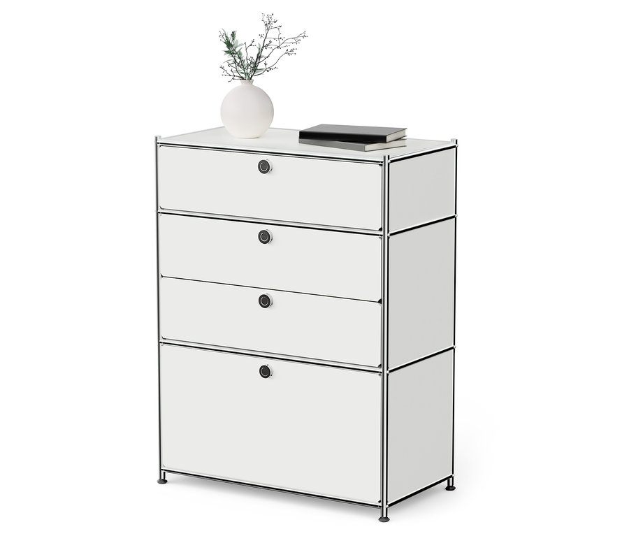 Fehér »CN3« fém komód 3 fiókkal és egy lenyíló ajtóval. A komódon egy váza növény és egy könyv található.