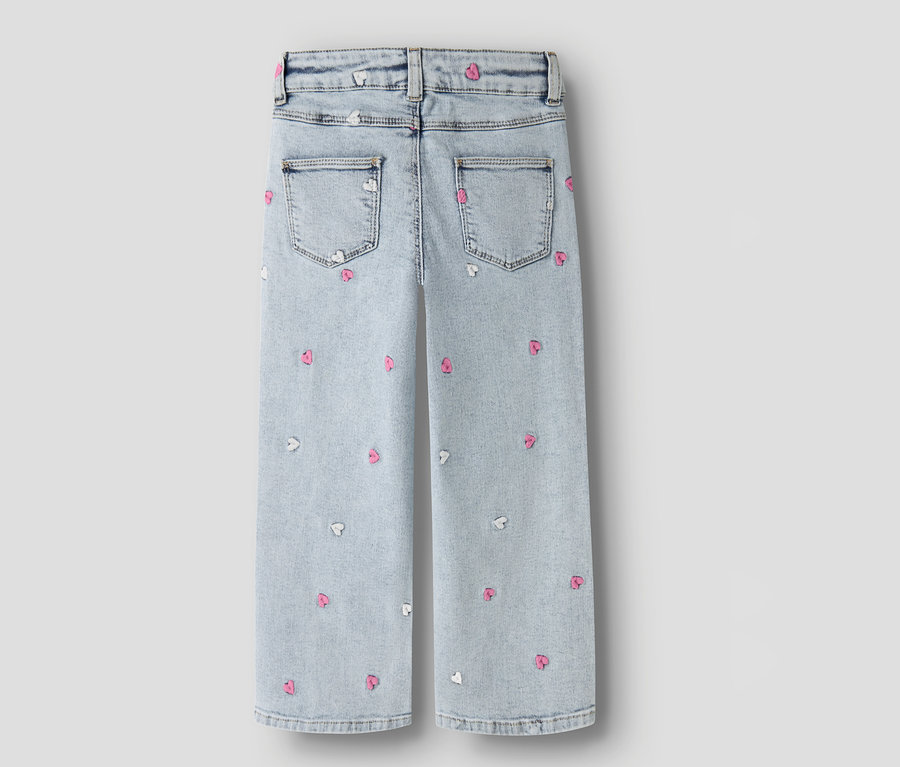 Hátulnézet egy világoskék NAME IT Wide Leg farmernek, rózsaszín és fehér szívekkel.