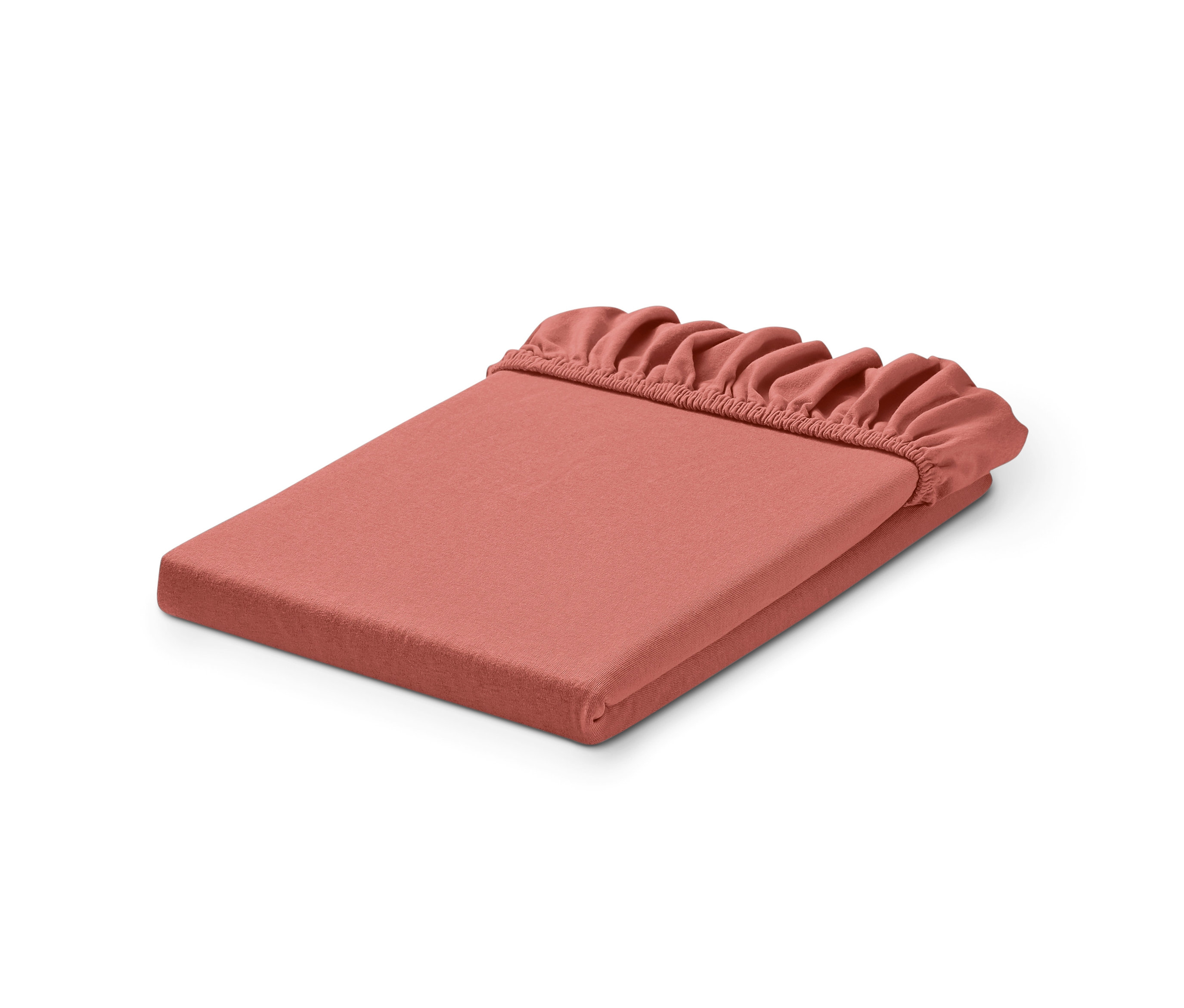 Egy rózsaszín jersey gumis lepedő, kétszeresen összehajtva.