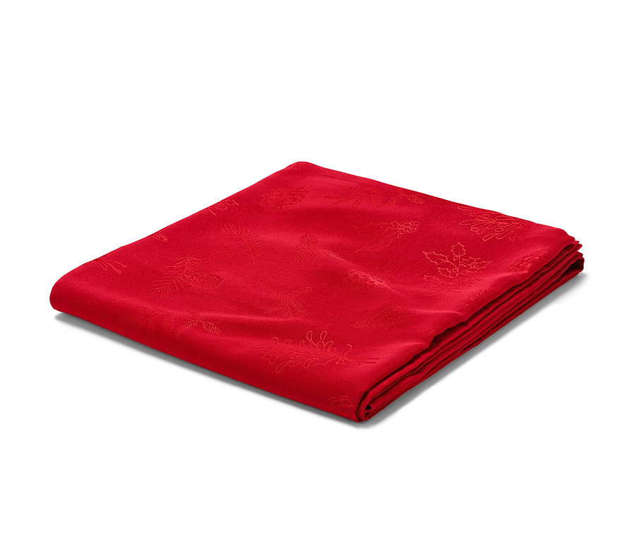 Összehajtott piros jacquard asztalterítő.