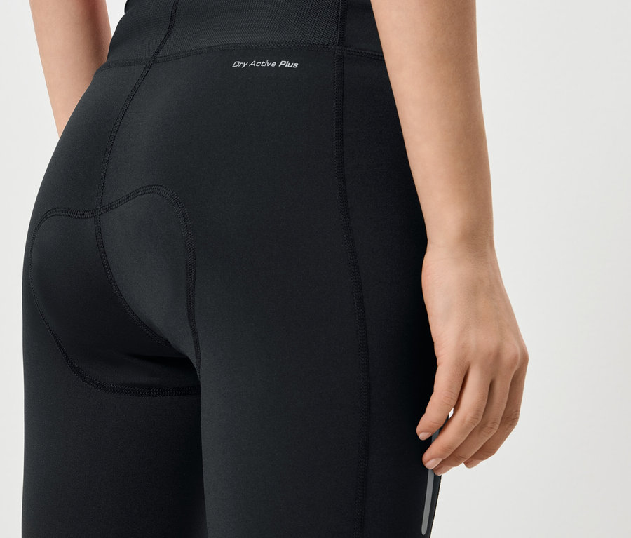 Közeli kép egy nő hátulról, aki fekete leggingset visel „Dry Active Plus” felirattal.