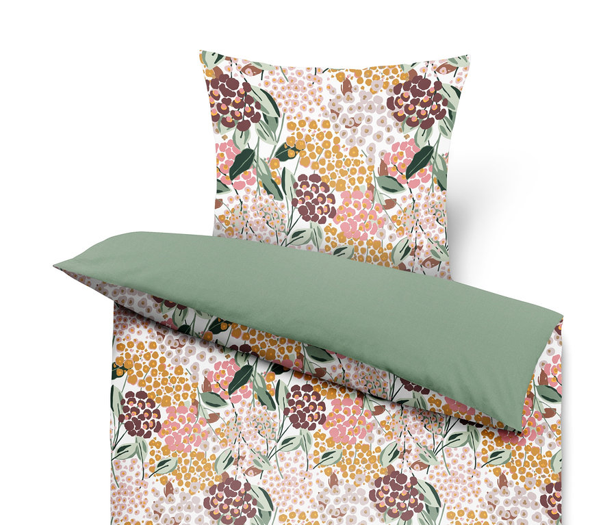 Virágmintás ágynemű zöld párnával.