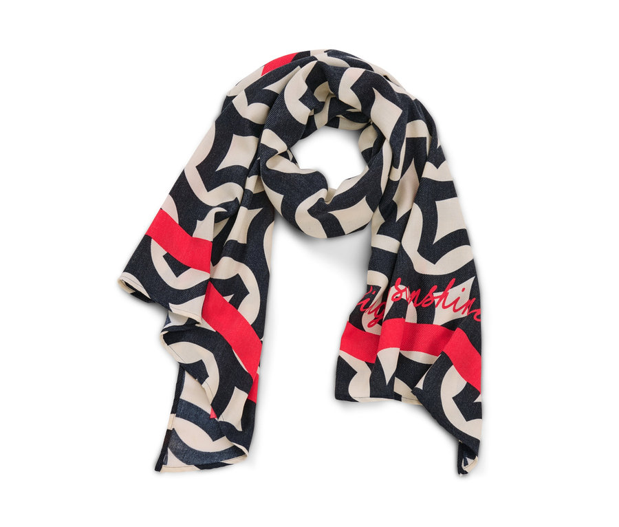 Egy mintás, szövött sál részlete krém, sötétkék és piros színekben.