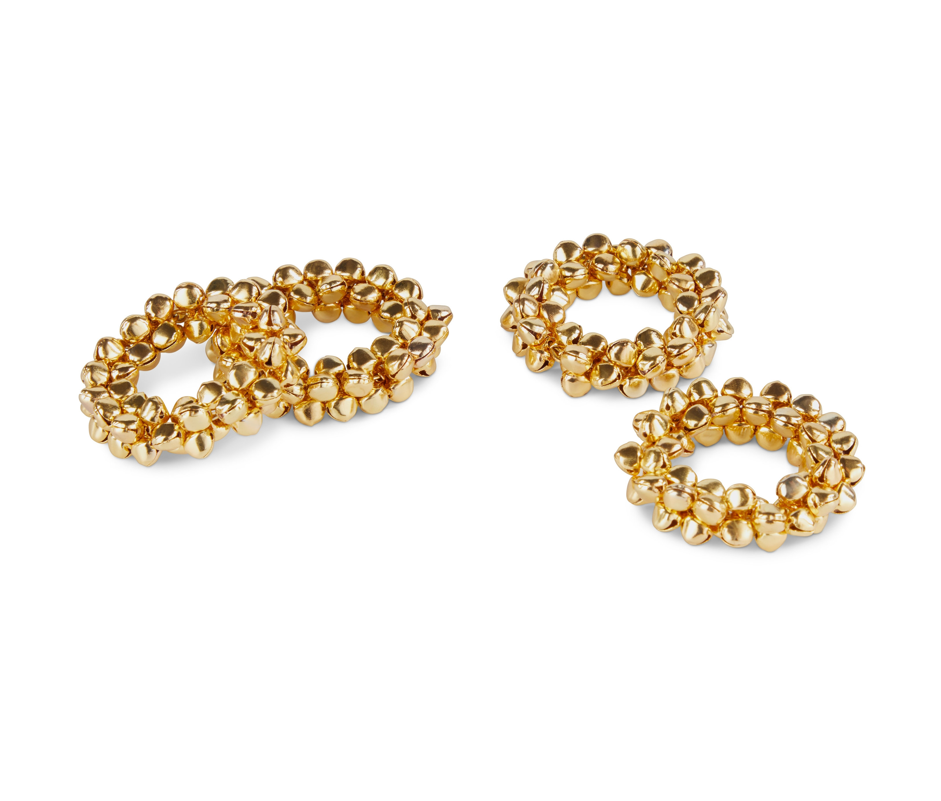 Négy arany színű szalvétagyűrű fehér háttéren.