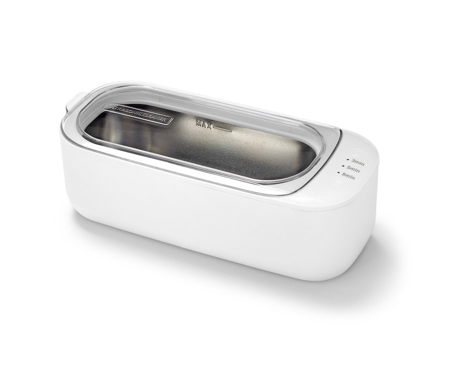 Fehér ultrahangos tisztító átlátszó fedéllel.