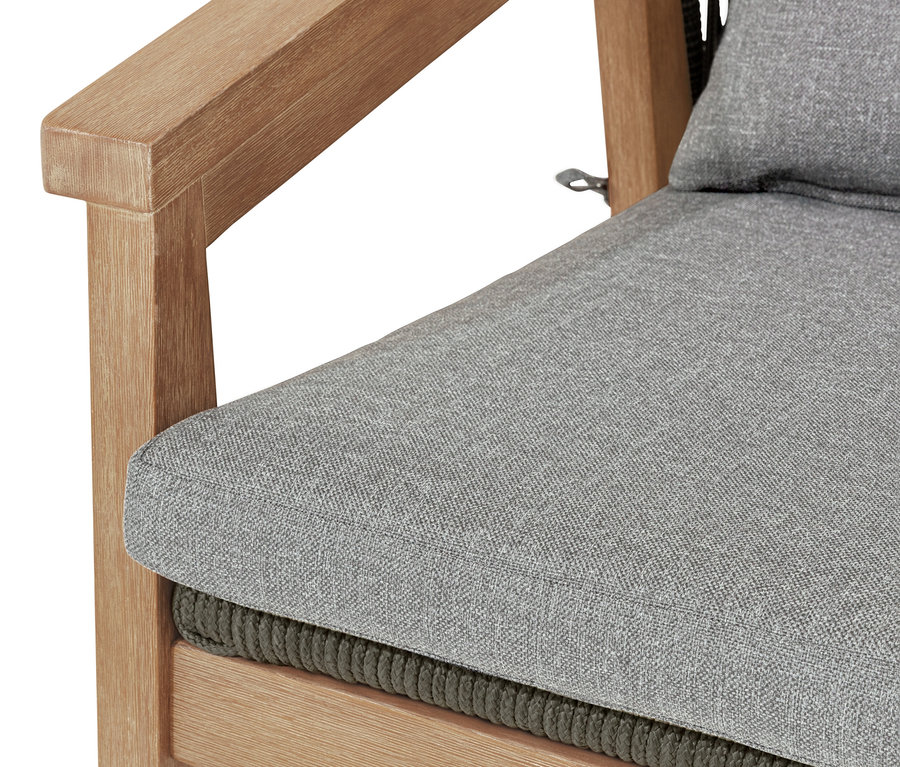 Közeli kép egy karosszékről kerek hátlappal és textilhálóval, az ülés és a háttámla szürke.