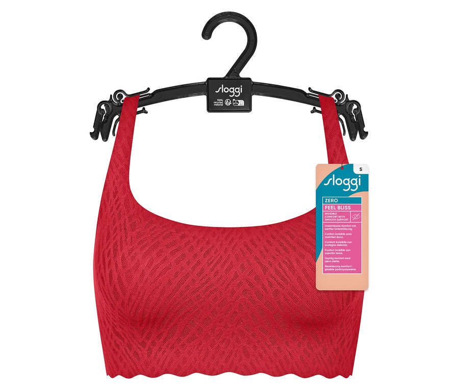 Egy piros sloggi ZERO Feel Bliss ünnepi top lóg egy fekete akasztón.
