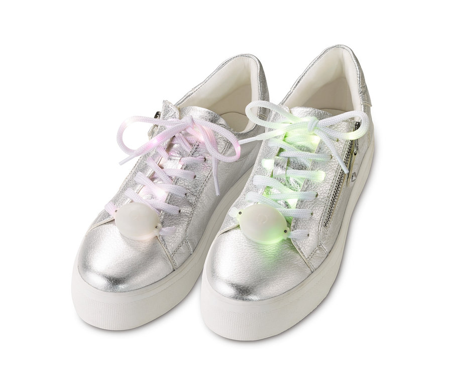 Ezüst színű tornacipők LED-es cipőfűzővel, az egyik rózsaszín, a másik zöld fényű.