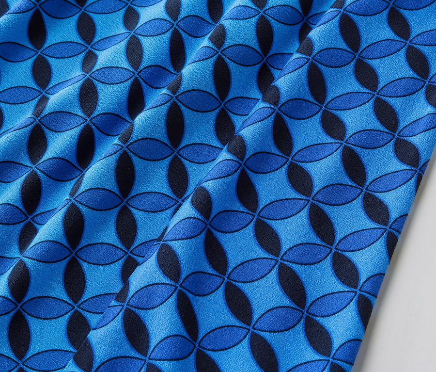 Egy mintás, kék női midiszoknya részlete.