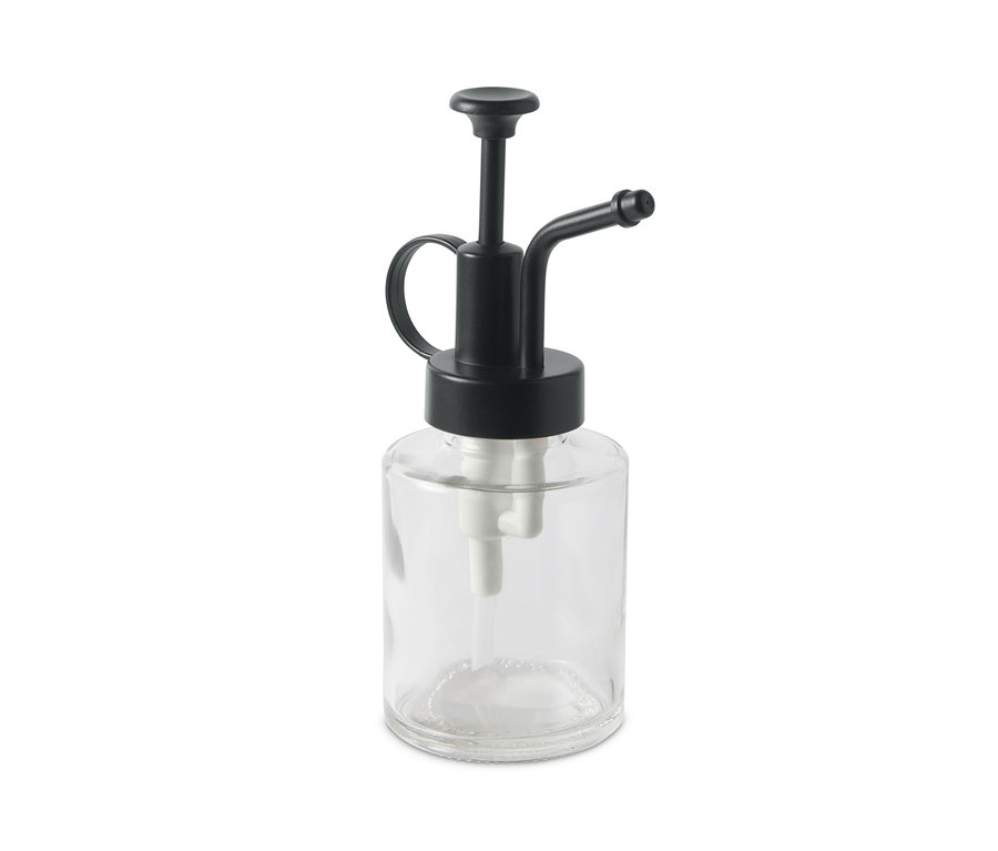 Egy átlátszó növény permetező, fekete pumpával.