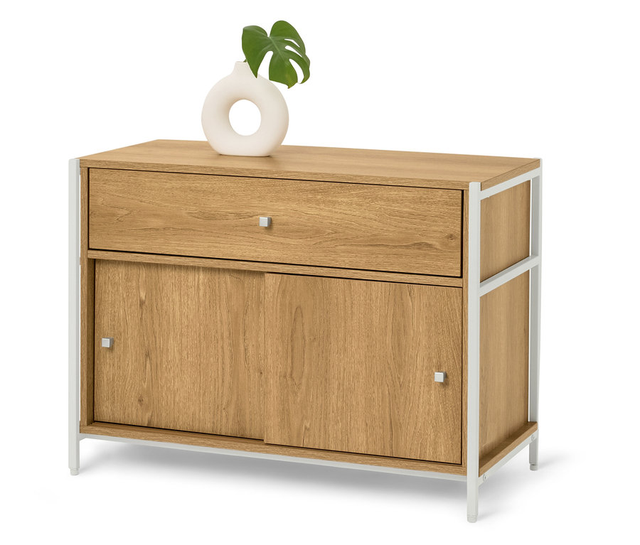 Világos fa komód fehér fém lábakkal, tetején egy fehér váza zöld levéllel.