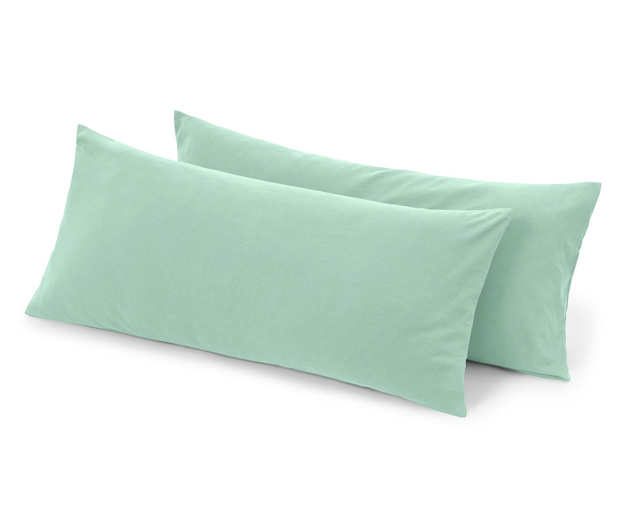 Két világoszöld testpárna fekszik egymáson.