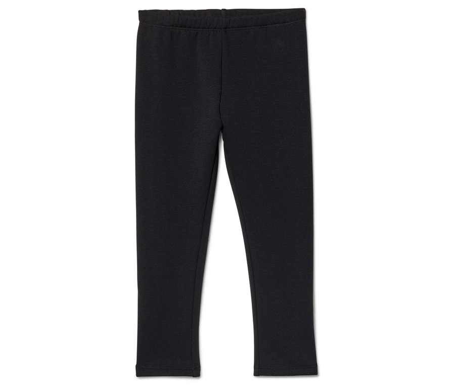 Fekete, gumis derekú leggings fekszik fehér háttéren.