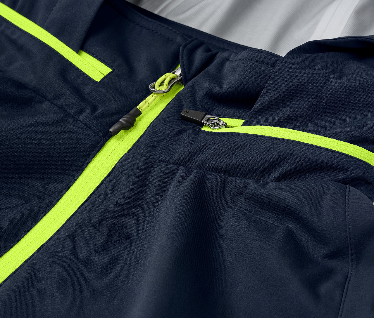 Egy Rad-Regenjacke közeli képe neon sárga cipzár részletekkel és szegésekkel.