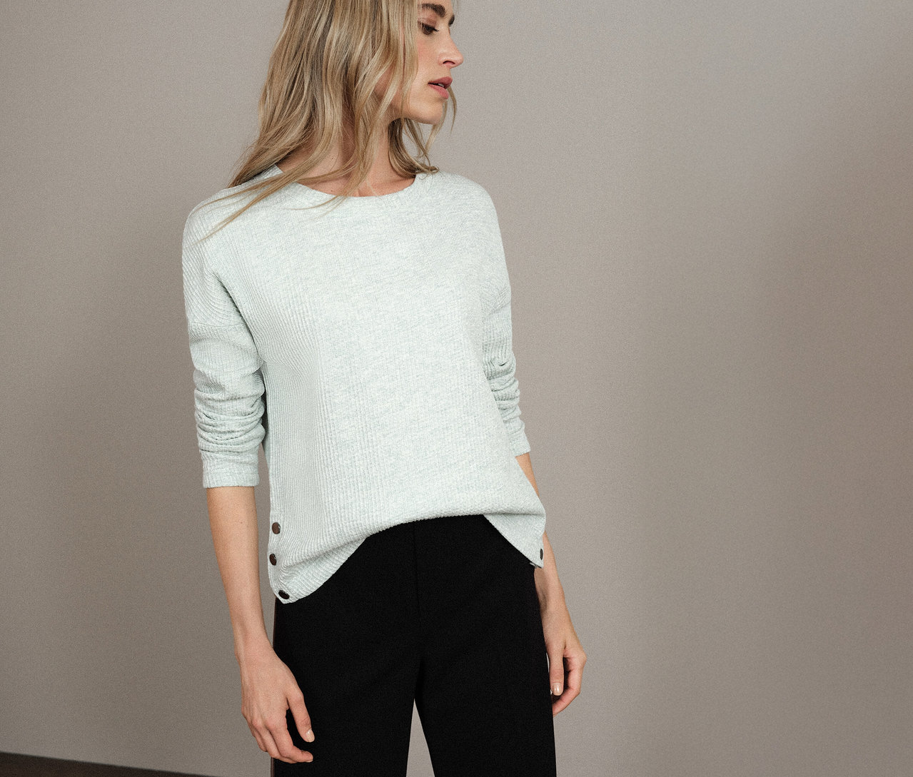 Nő világoskék Street One bordás mintás pólót és fekete nadrágot visel.