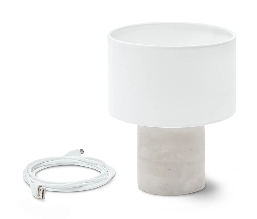 Egy LED-es asztali lámpa beton talppal, akkus, töltőkábellel.