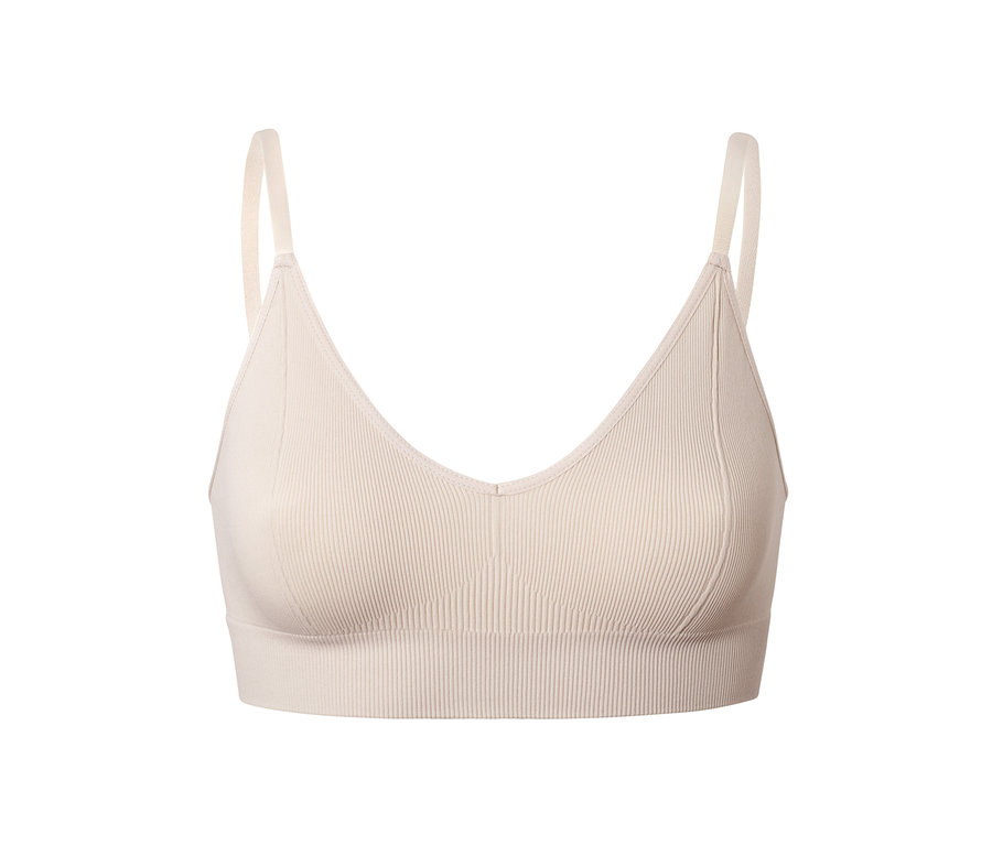 Egy bézs színű női seamless bustier melltartó részletfotója.