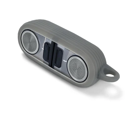 Szürke mágneses Bluetooth hangszóró fehér háttérrel.