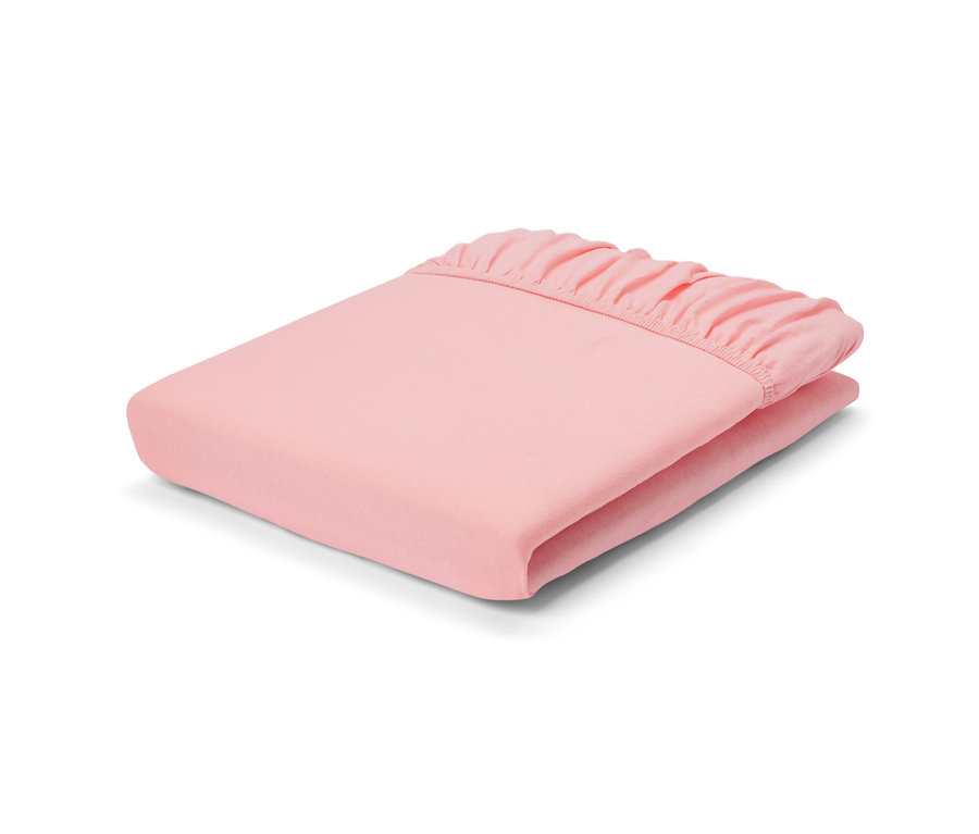 Összehajtott barackszínű gumis jersey lepedő normál, kétszemélyes és extra méretben.